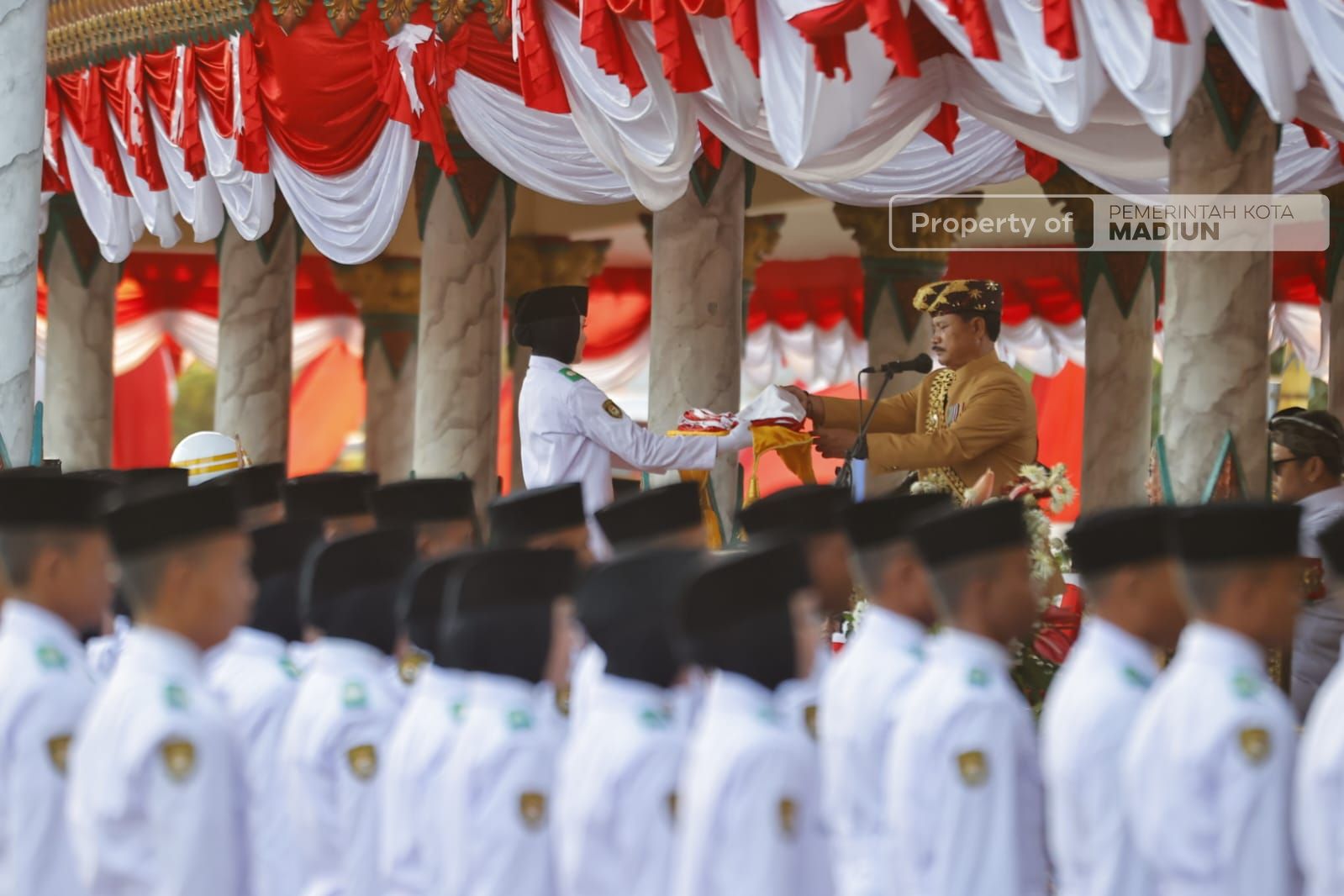 Foto 3 dari 9: Upacara Penurunan Bendera Berlangsung Khidmat, Peserta Kenakan Pakaian Adat